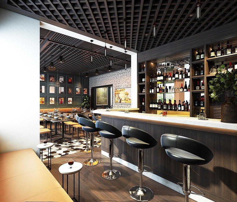 The interior of a modern restaurant complete with matte black walls, half-back bar stools, and couch style seating