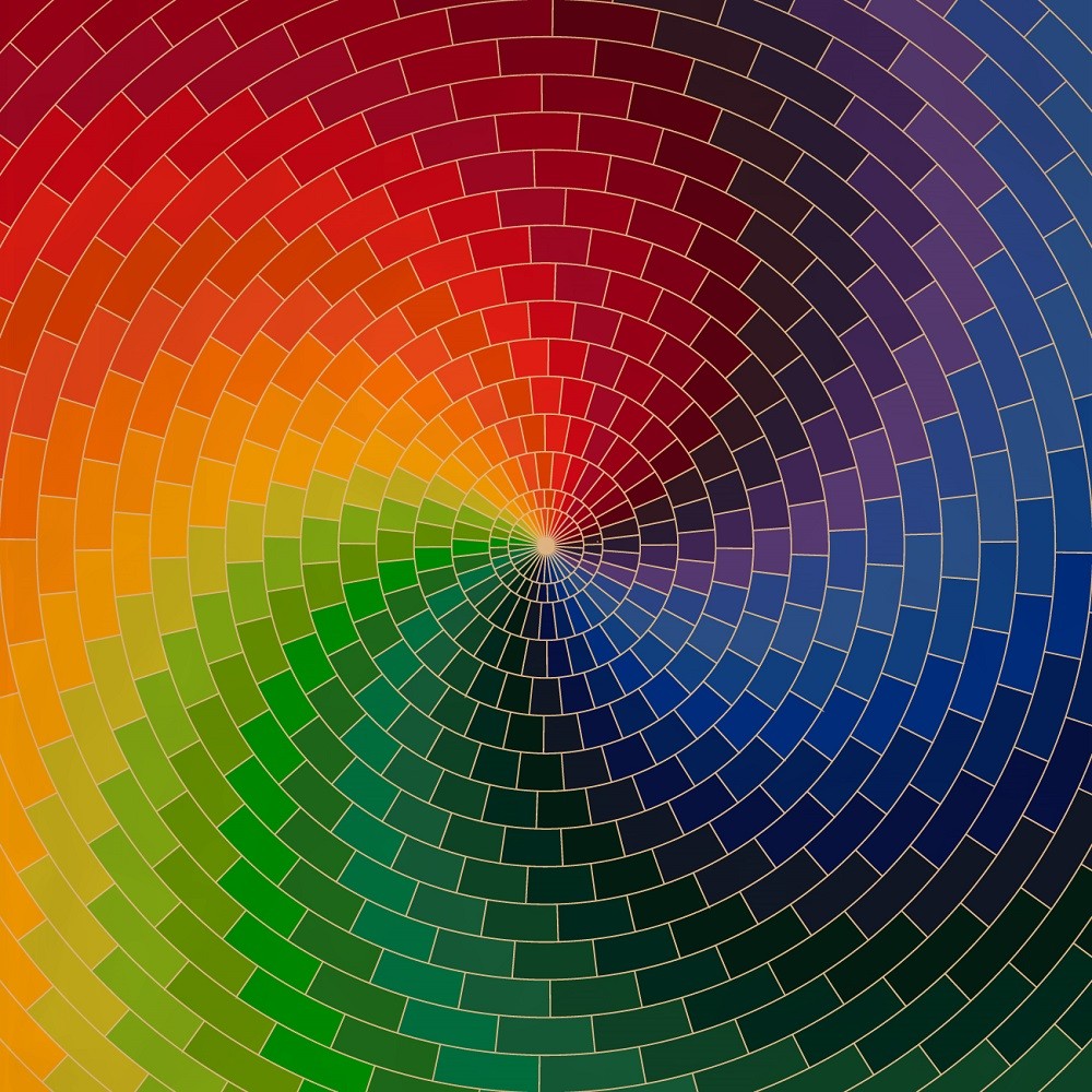 A swirling colour wheel shows how two different colours can create a new colour, like red and blue create purple. In this picture the colours red and blue are near each other but separated by different shades of purple with darker shades near blue and lighter shades near red