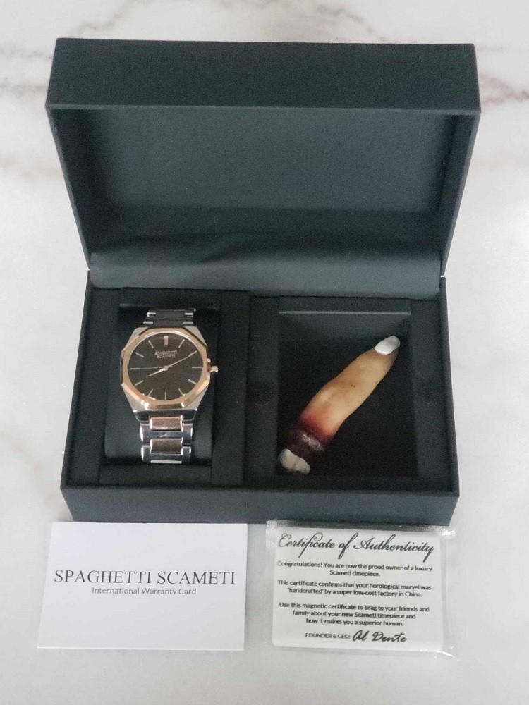 A look inside the box of the Spaghetti Scameti iCon box reveals the watch and a plastic finger (a gag to play off the brands name and scammy job)