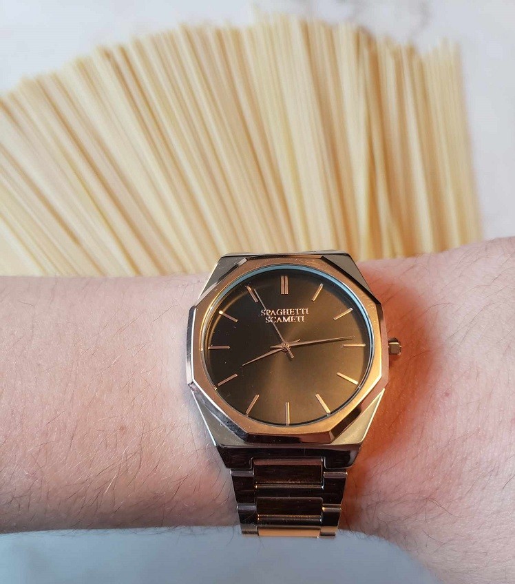 A Spaghetti Scameti iCon watch sits in front of a box of spaghetti