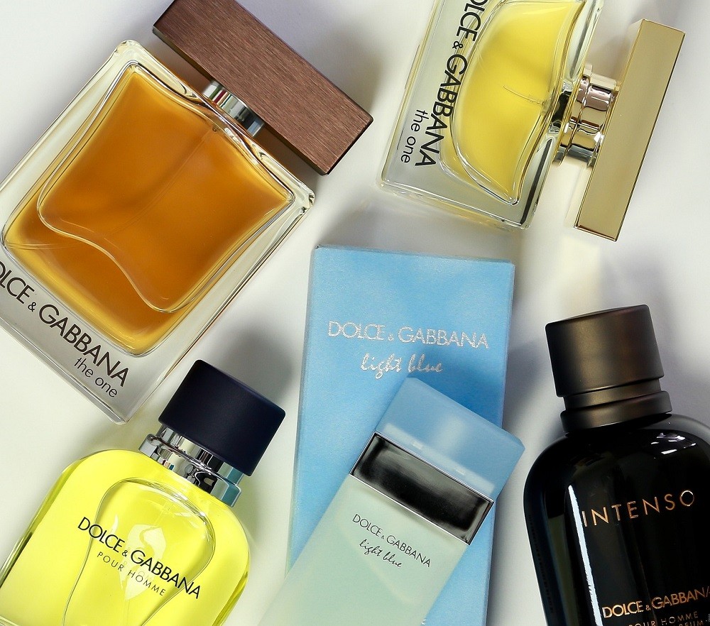 An array of Dolce & Gabbana fragrances are laid out on a table. Most of them are flankers of others, meaning they're part of the same line but feature different notes