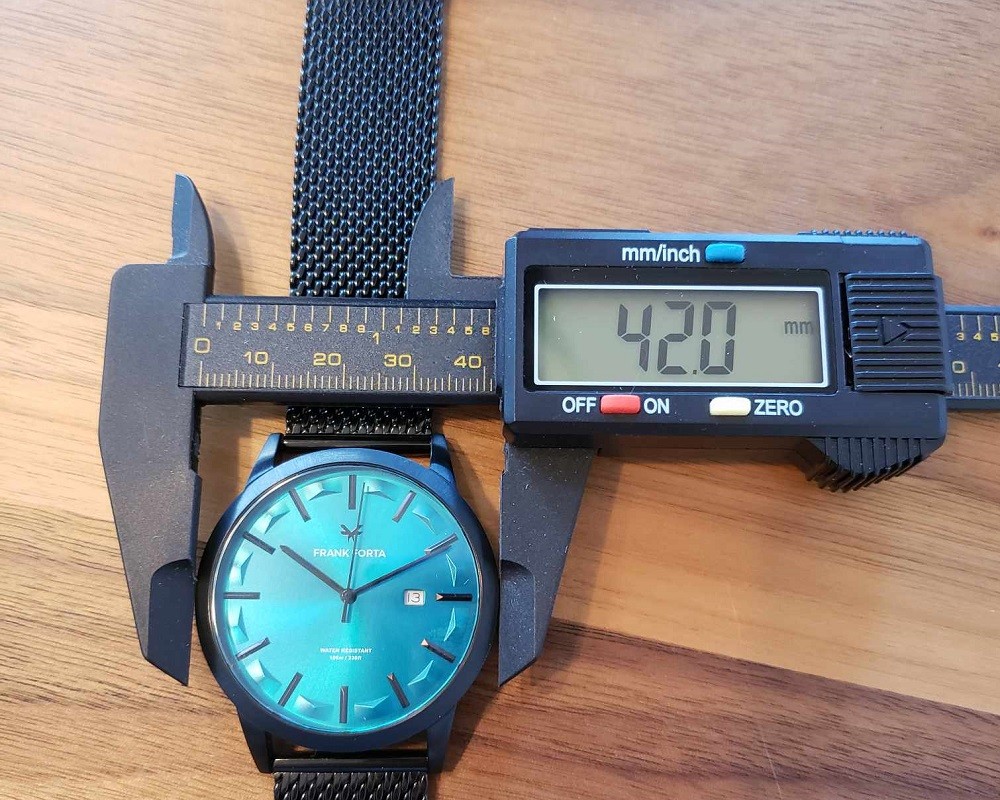 Calipers are used to measure the width of the Frank Forta Moraine Lake watch. The measurement on the calipers show 42mm