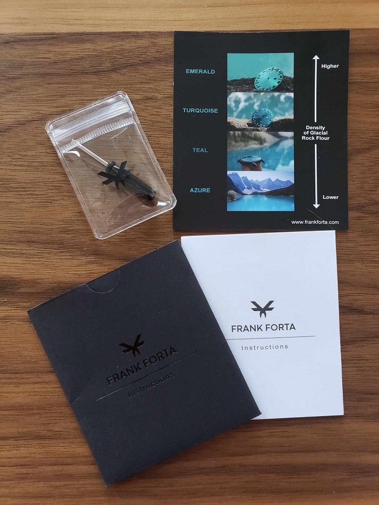 The manual for the Moraine Lake watch by Frank Forta is displayed along with a small tool used to adjust and change the strap on the watch
