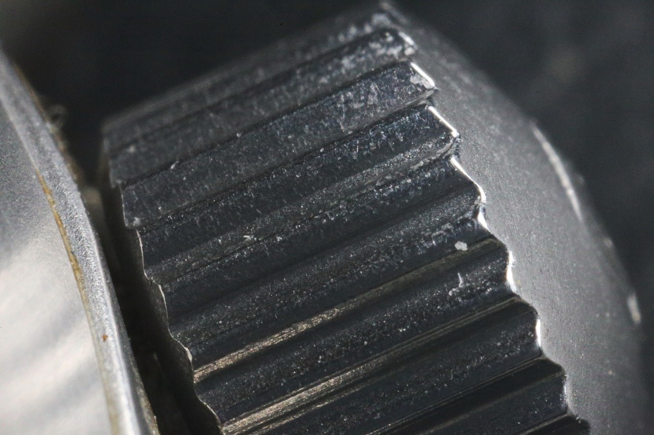 A close-up look at the crown of a watch. The grooves are visible