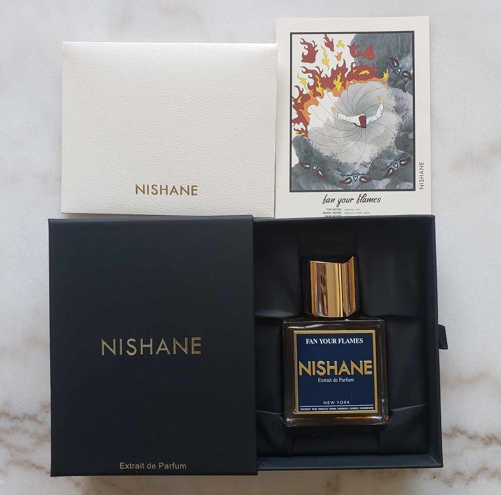 Fan Your Flames by Nishane comes nested inside a black box with a silk-like fabric surrounding it