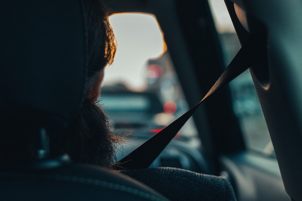 A person wearing their seatbelt in a vehicle