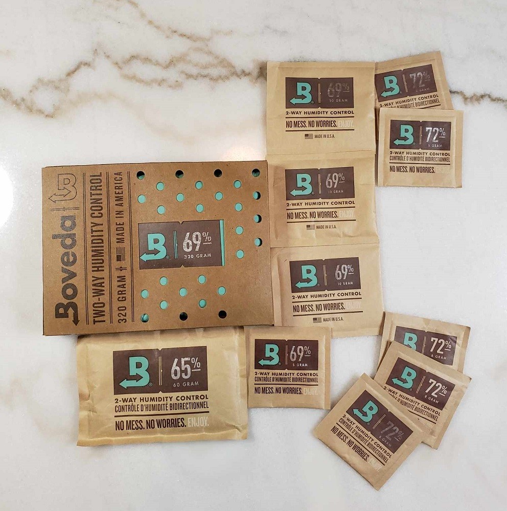 A variety of different sized Boveda packs are laid out on a table