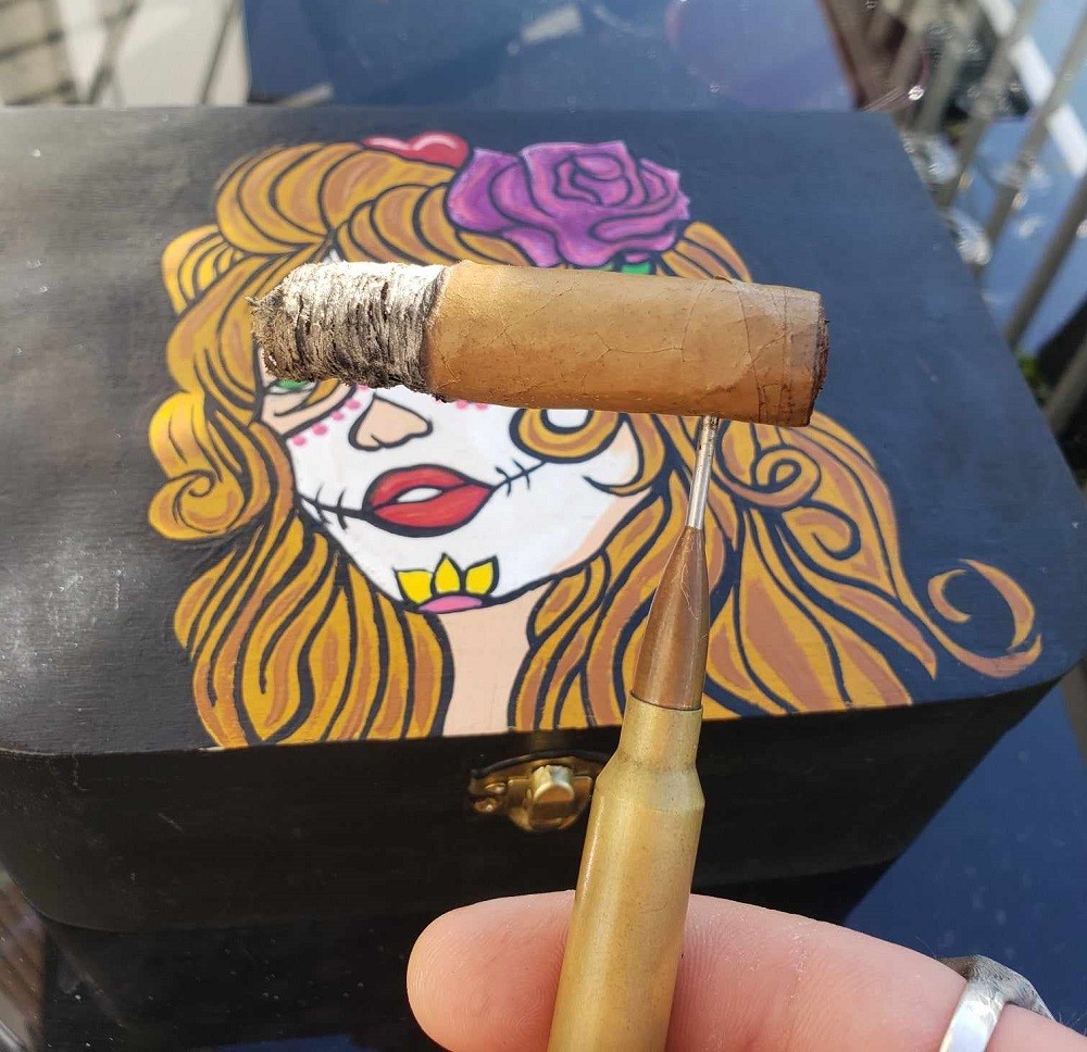 The light brown Cha Cha Sugar cigar now has the band removed. It has about an inch of ash on it and is about 3