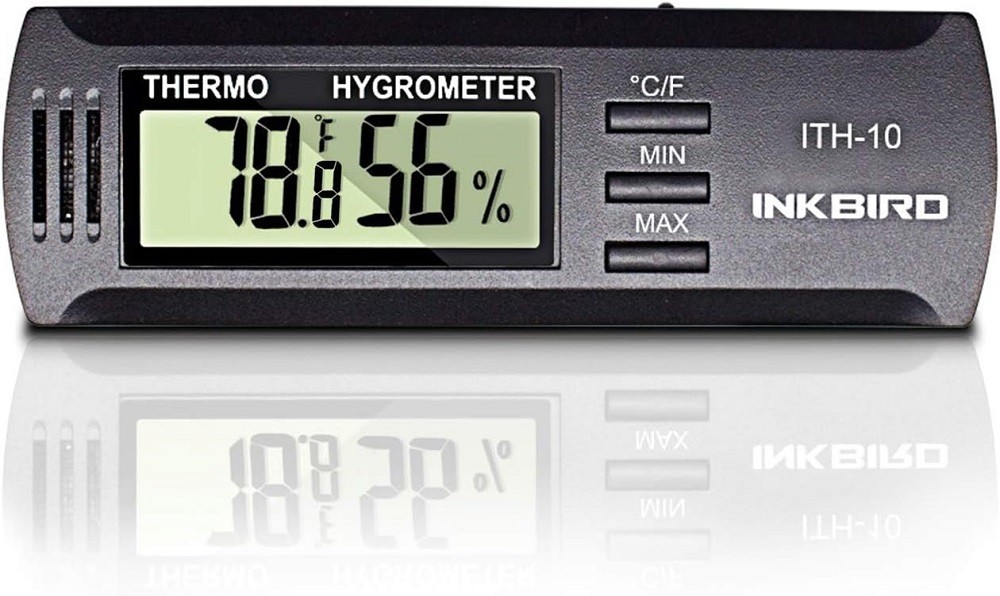 A stock photo of a digital hygrometer showing the temperature and relative humidity readings on a clear, easy to read screen