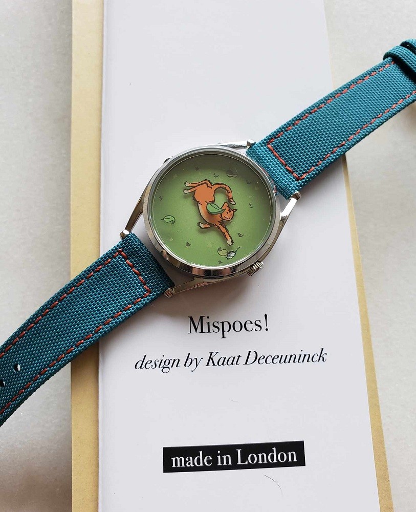 Mr Jones Watches Mispoes cat watch sitting on a piece of paper with the artists name on it