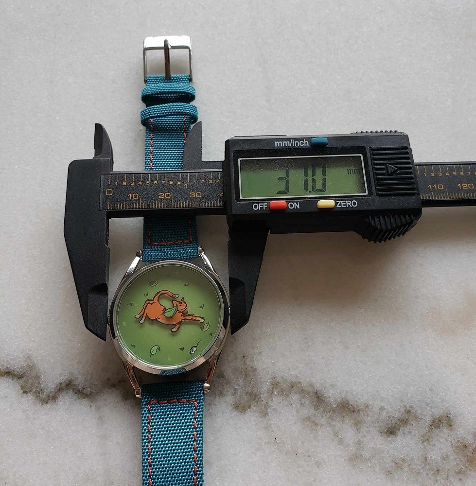The Mispoes watch by Mr Jones watches measures 37mm across. A caliper is used to verify and display the accurate measurement