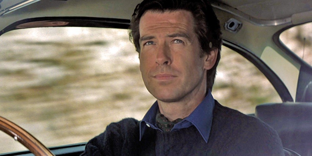 Pierce Brosnan portraying James Bond in Goldeneye is wearing a signature green cravat under his blue collared shirt and dark blue sweater