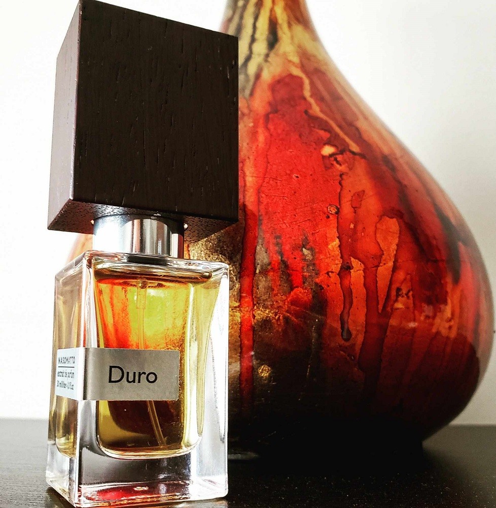 Duro by Nassomatto comes in a small, clear, rectangular bottle with a large brown cap with a wood grain pattern on it