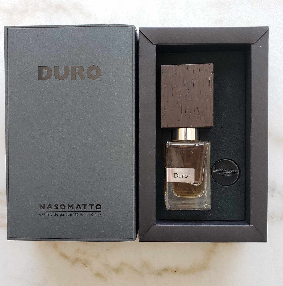 An open box of Duro cologne by Nasomatto. It has the cologne nesting in a black Styrofoam box