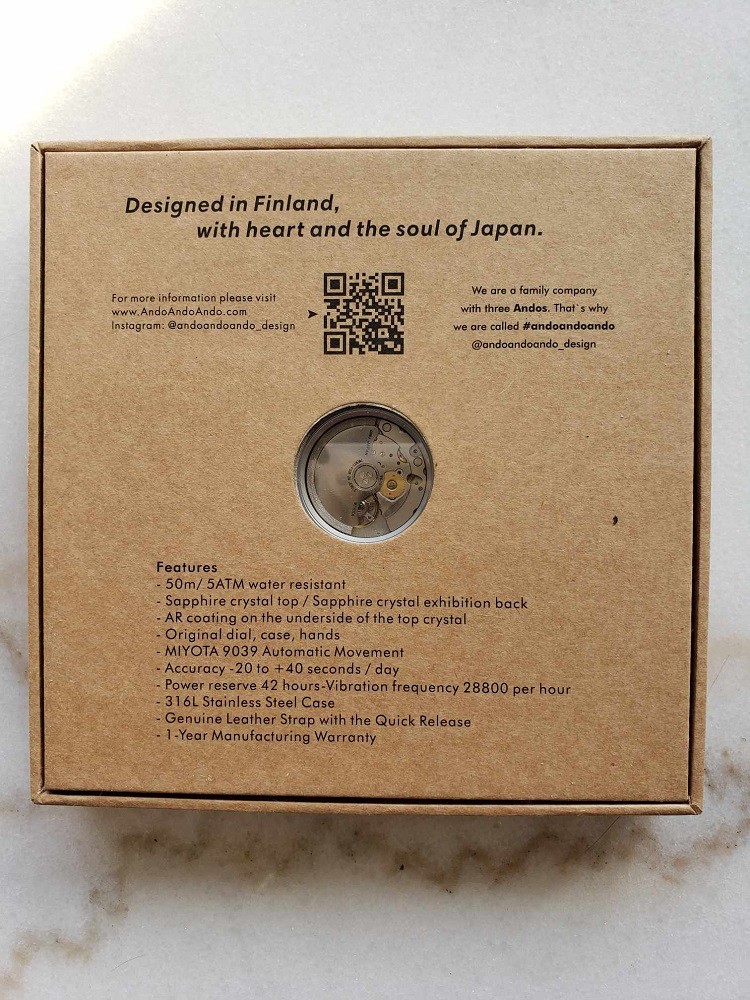 The back of the box that contains the Vinyl Record Watch by AndoAndoAndo. It displays important information about the watch including the movement, water resistance, and a QR code instruction manual