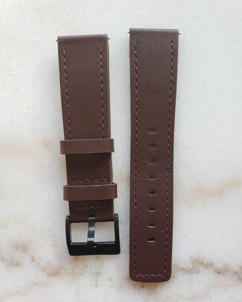 A picture of the brown leather straps included with the Vinyl Record Watch by AndoAndoAndo. One piece has a black buckle with the company logo on it