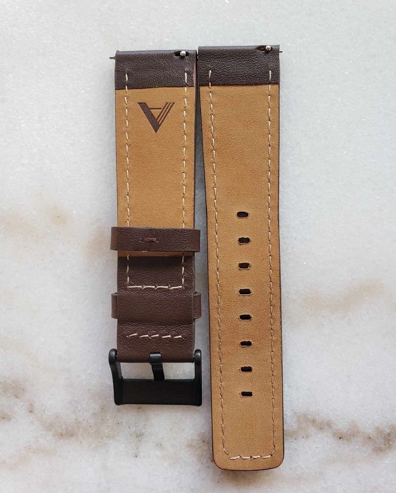 A picture of the back of the brown leather straps that are included with the Vinyl Record Watch by AndoAndoAndo. They have the company logo