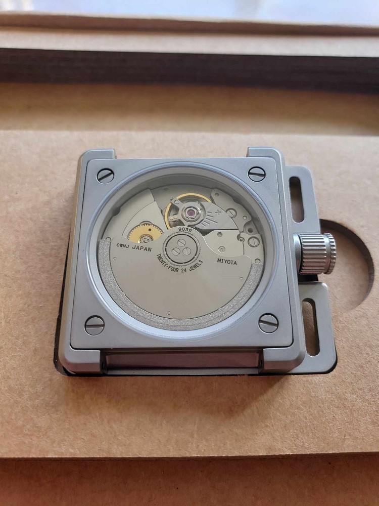Vinyl Record Watch by AndoAndoAndo showcasing the Automatic Movement in an exhibition caseback. You can see all the gears, rotor, and springs that make the watch run
