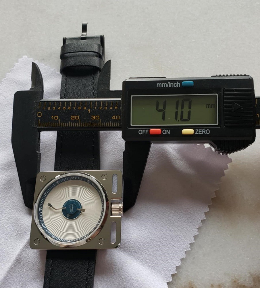 A watch measurement tool is used to measure the width of the Esteemed Gentleman Vinyl Record Watch. It is 41mm wide