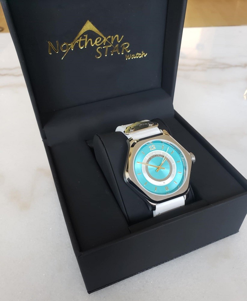 The Northern Star Watch black box opens and proudly displays the Sentinel watch. The watch sits on a black cushion. The brands name is on the top portion of the inside part of the box in gold lettering