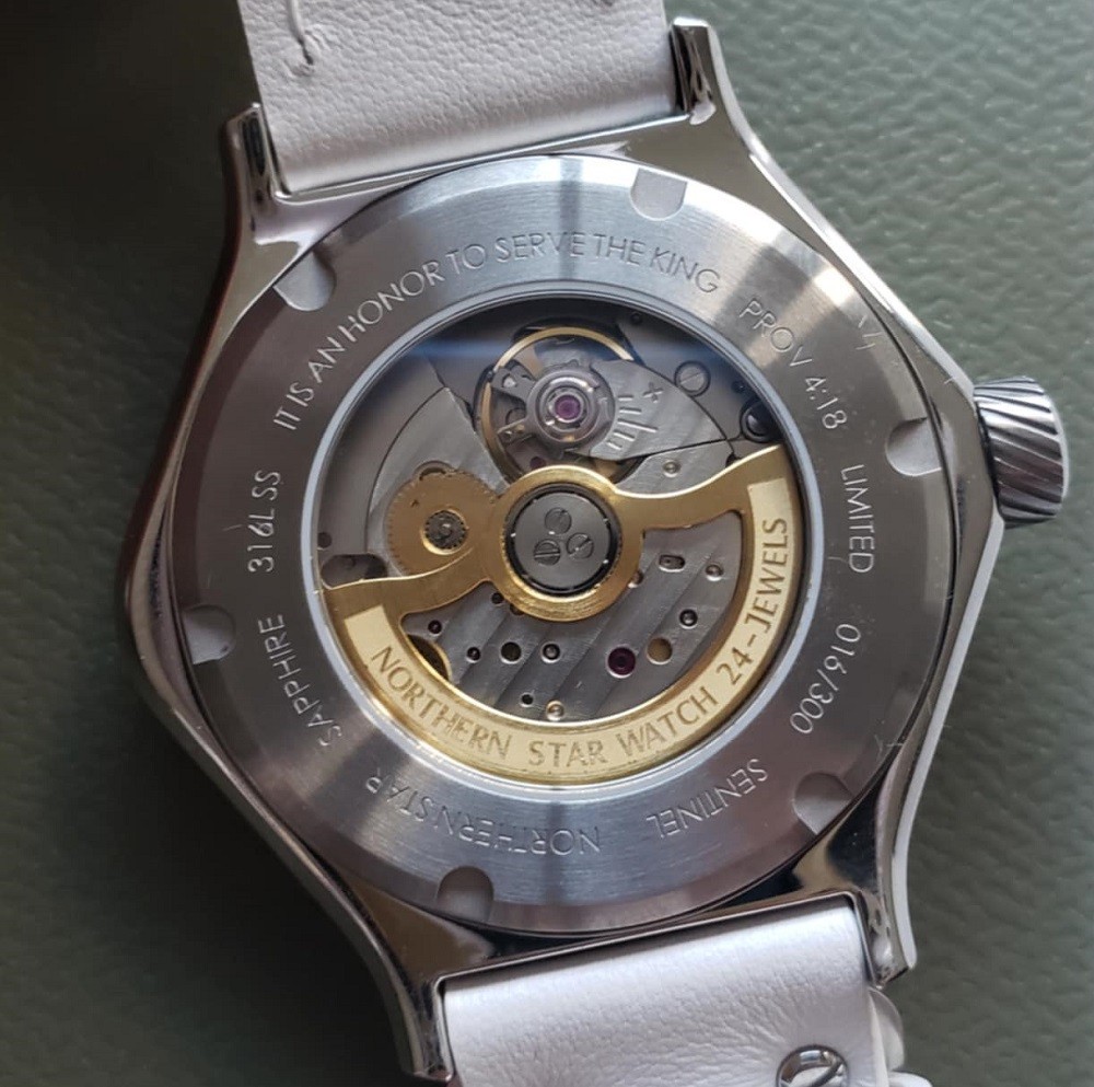 The Icy Sentinel by Northern Star Watch caseback has a small clear piece of glass allowing the viewer to see the movement inside. All the gears, springs, and jewels that make the watch run are visible