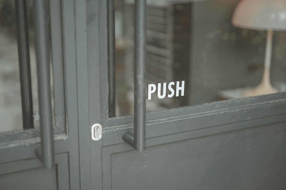 A dark green door with the word 