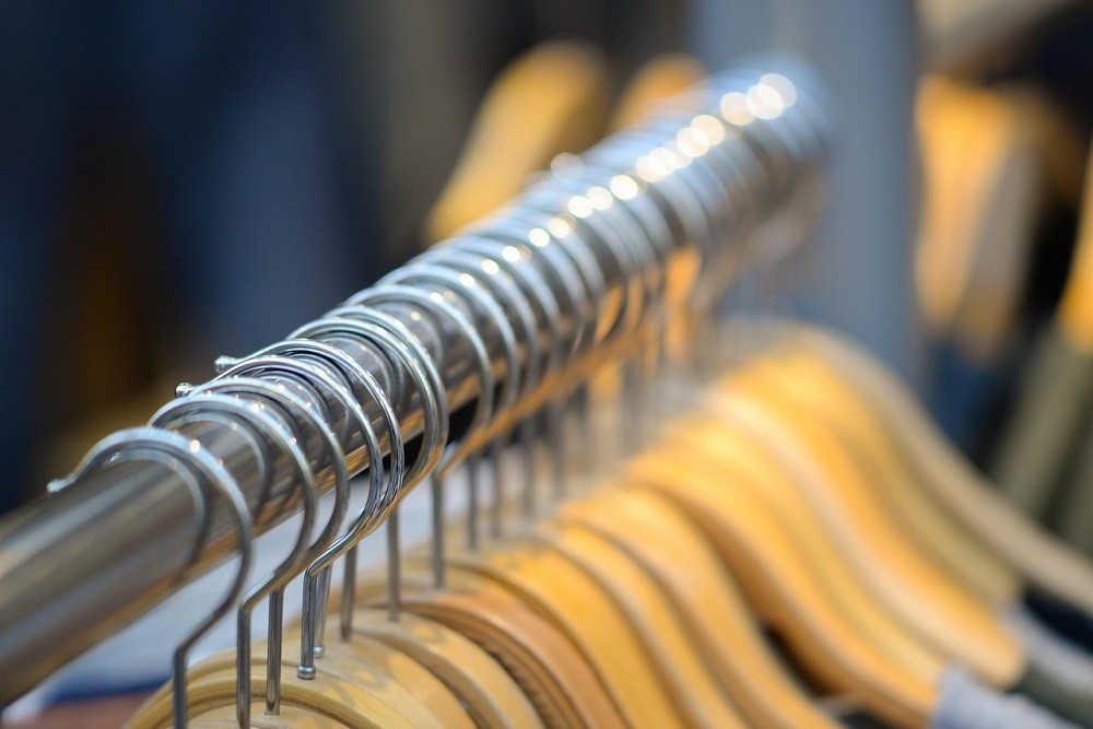 Dozens of empty coat hangers sit on a rack