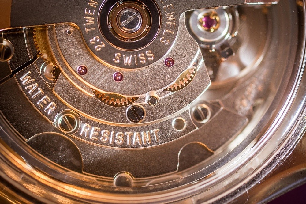 A close look at a watch movement. The rotor, gears, and jewels are clearly visible inside the watch case