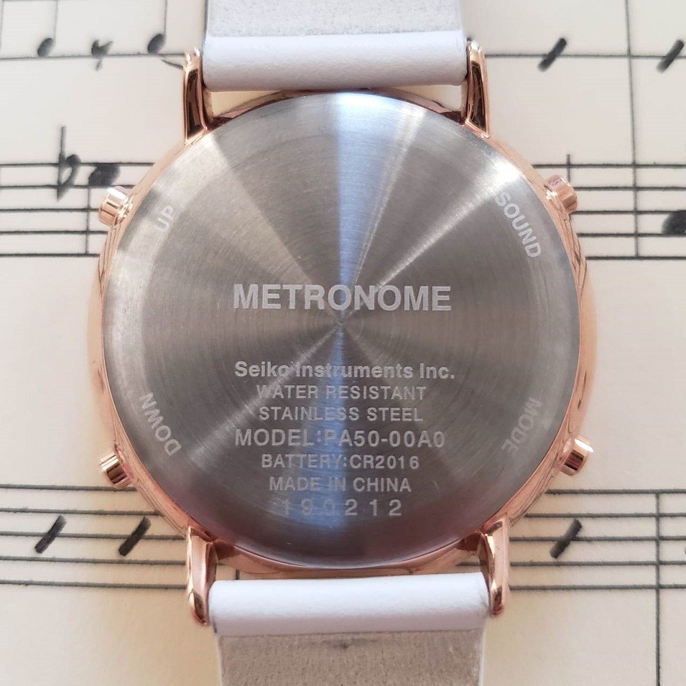 The caseback of the Seiko Metronome watch is shown. It is silver in colour and displays information including the name of the brand, water resistance rating, and serial number
