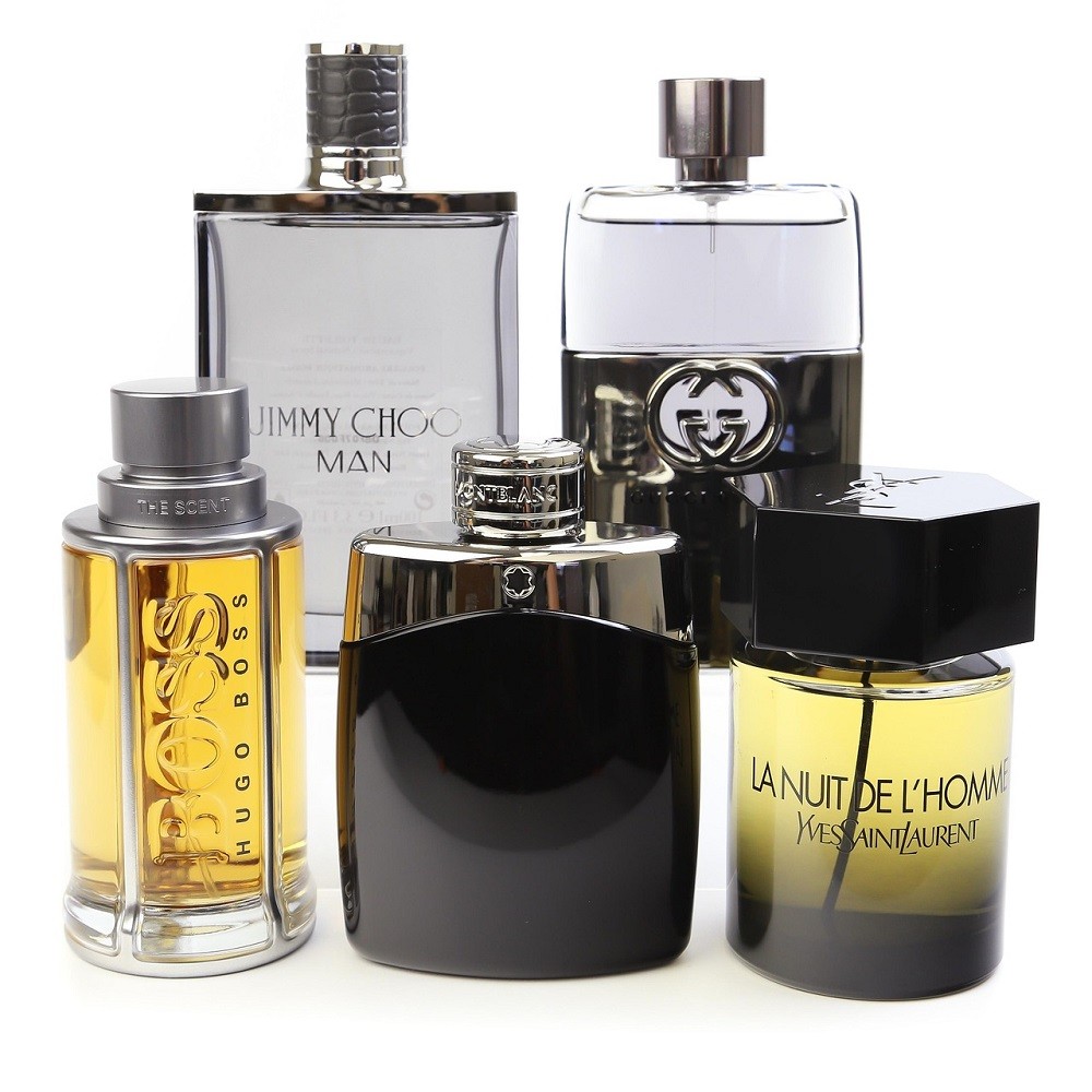 Several bottles of men's cologne are aligned so the taller bottles are in the back and the shorter ones are in front