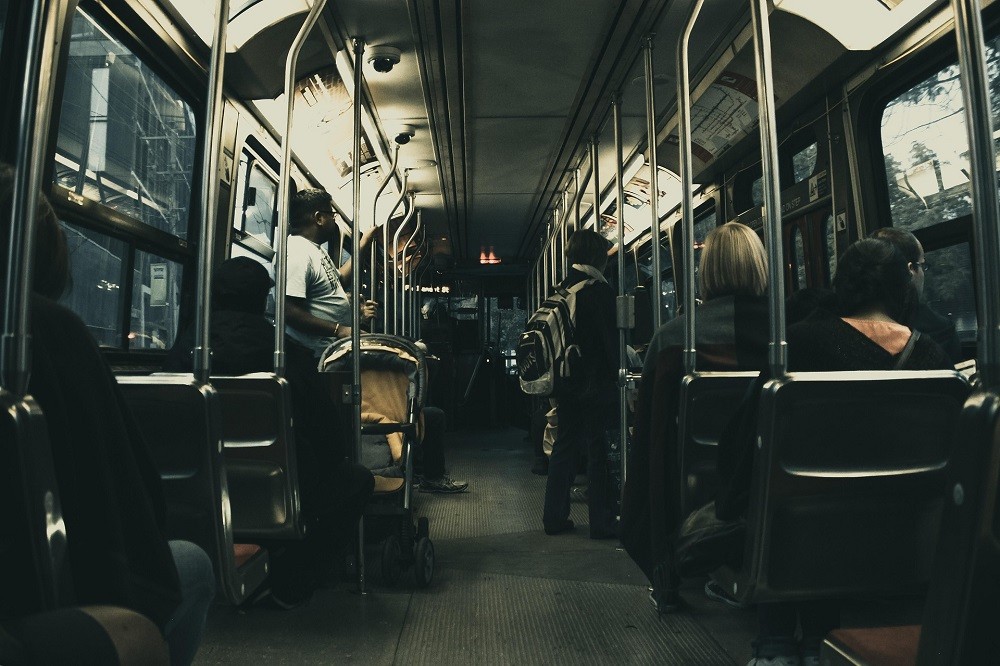 Several people are riding a bus