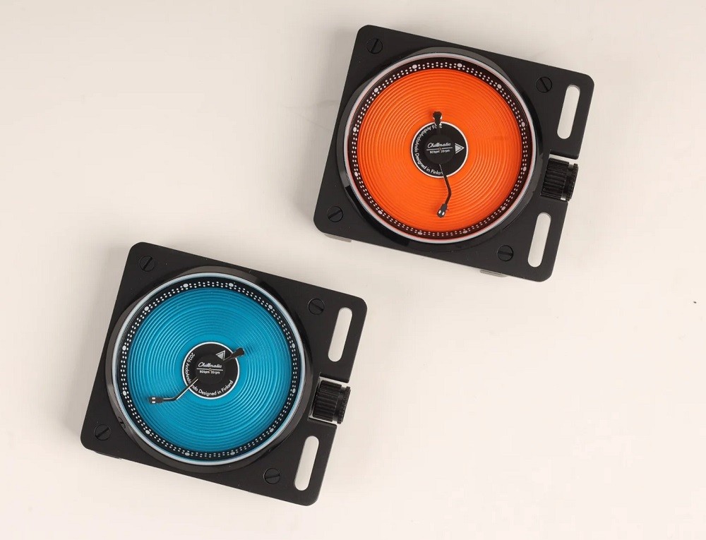 A bright orange watch and a bright blue watch are houses in square black cases