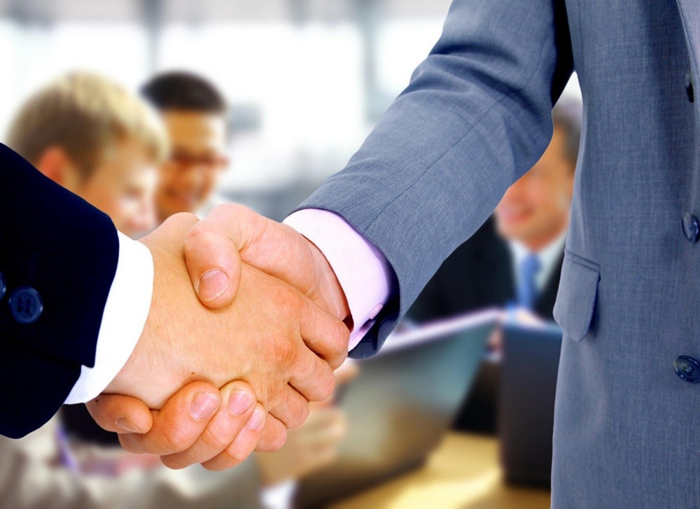 Two businessmen are greeting each other with a handshake