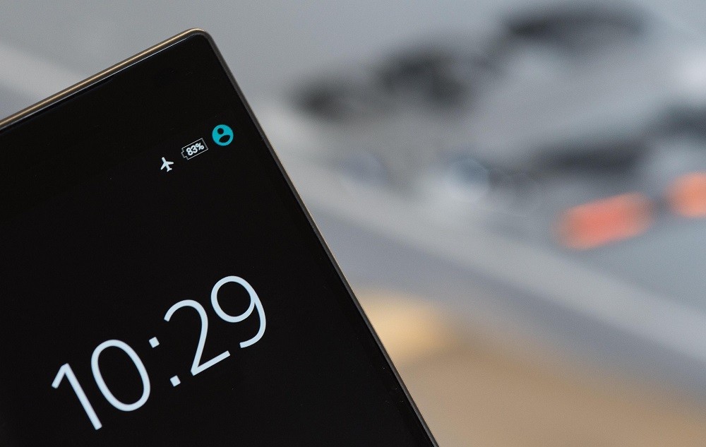 A smartphone displays the current time