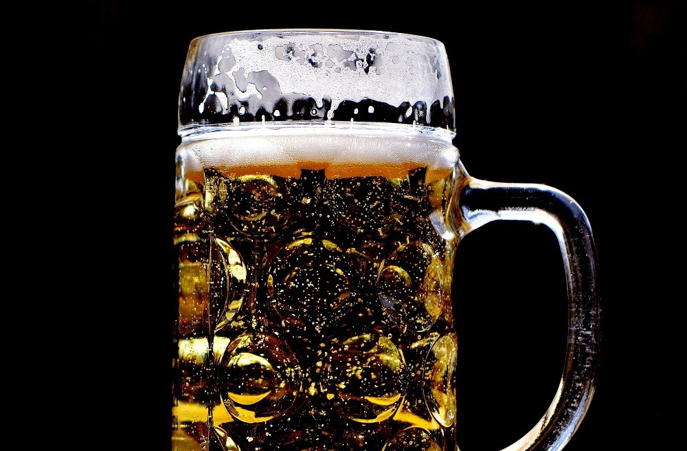 A frothy pint of beer with a foamy head