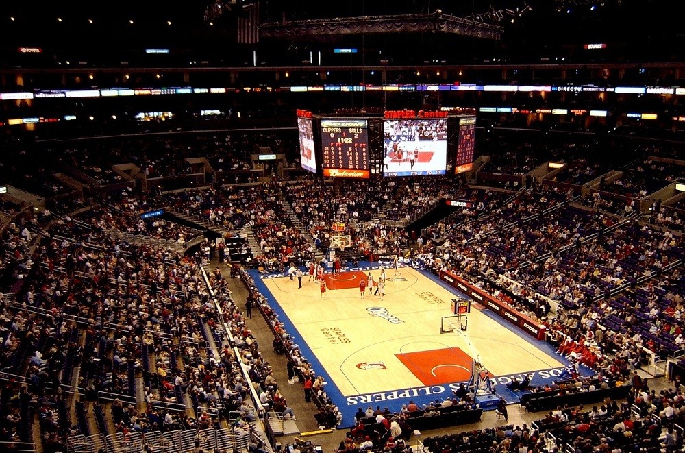 A basketball arena with fans heading to their seats