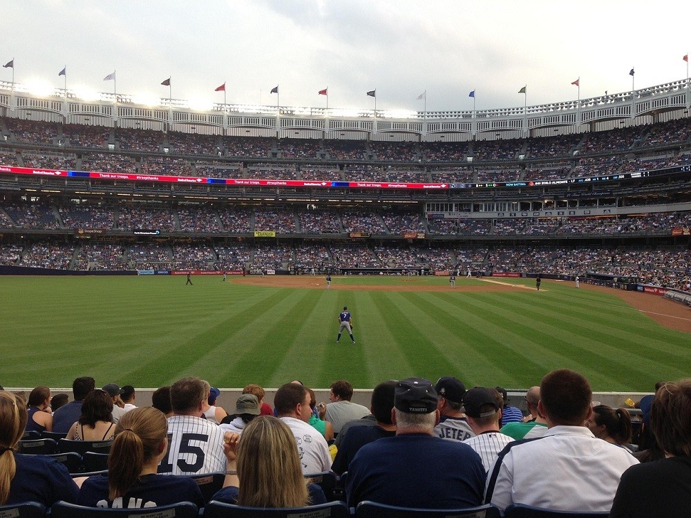 Fans at a baseball game sitting in outfield seats