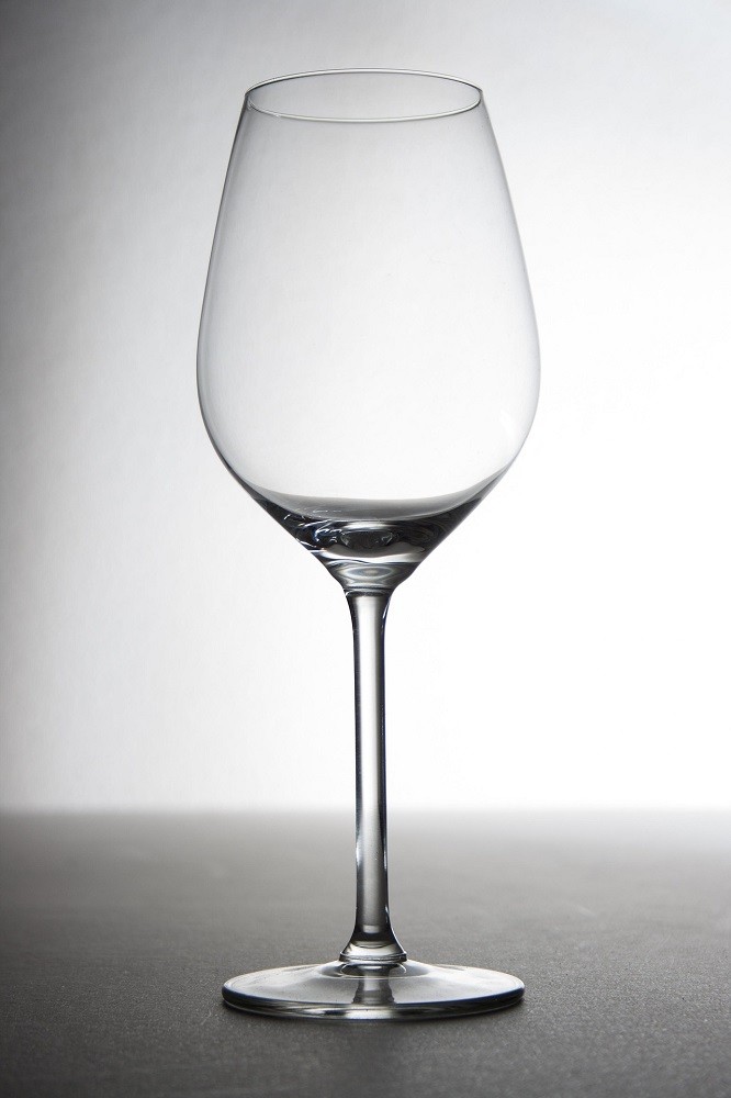 A clear wine glass is pictured