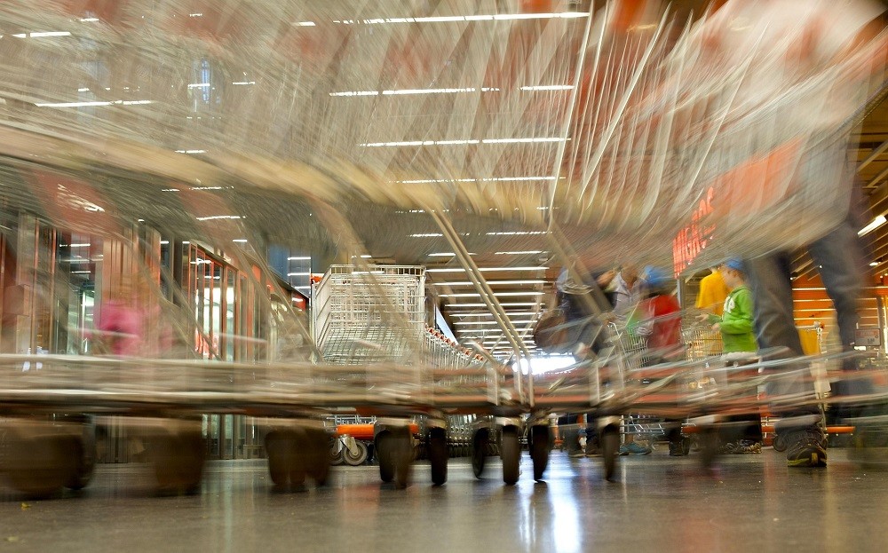 A blurry picture of shopping carts zooming by each other