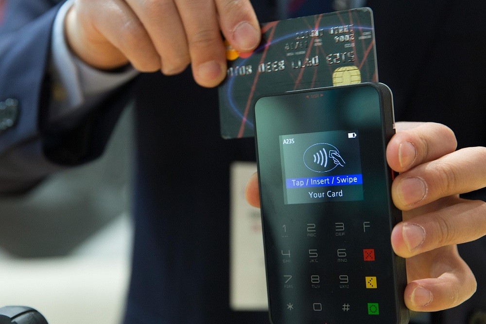 A man pays for a date with his credit or debit card