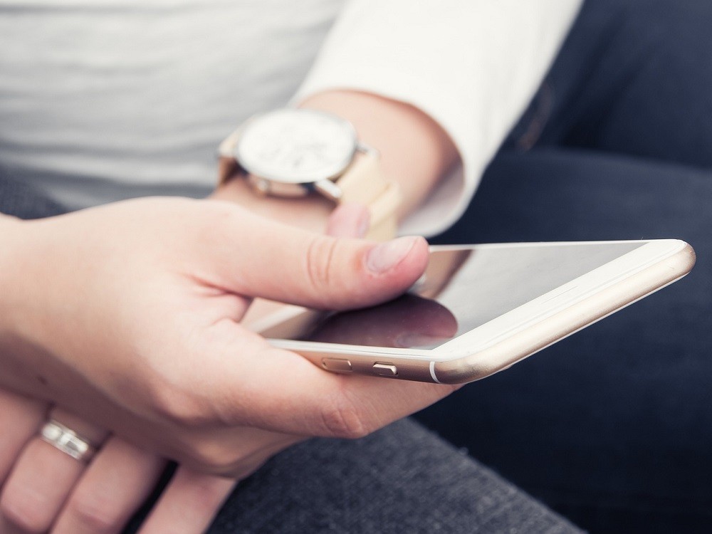 A man holding his smartphone in his hands