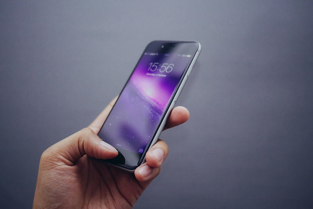 A man is holding a smartphone