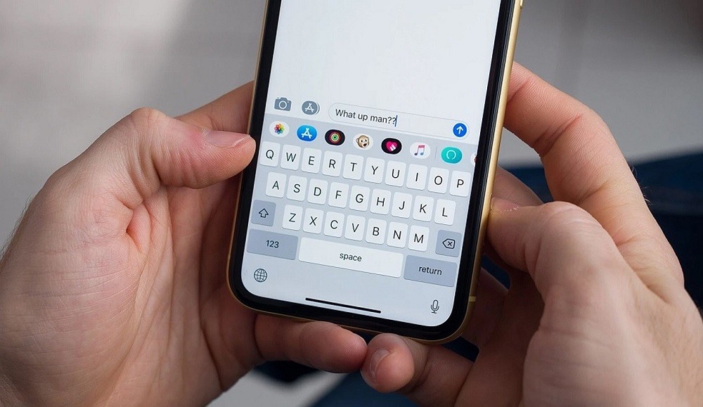 Someone typing on their smartphone
